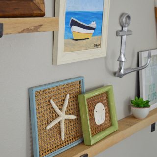 Learn how to style picture ledges in a gallery wall. Use my six steps and tips to create a beautiful themed gallery wall with a mixture of art and other items to add interest. A wall vignette is a fantastic decorating idea and solution for a large blank wall in a room.