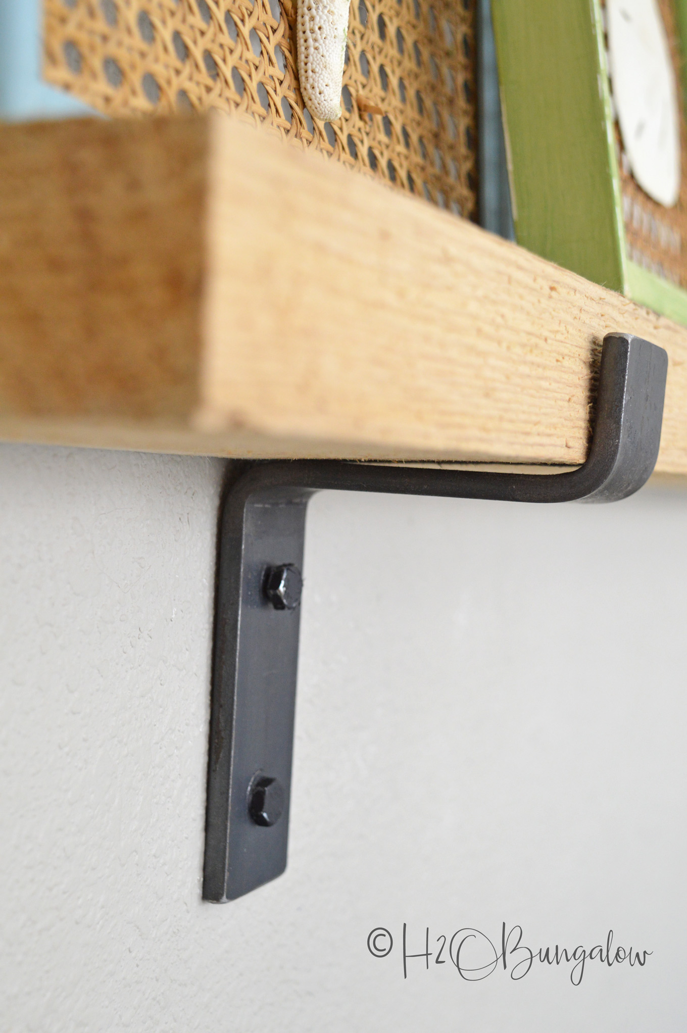 Tutorial on how to make a rustic modern DIY picture ledge and where to find the chunky industrial hardware.  Plus, simple step by step instructions on how to hang level picture ledges. Part 1 of 2, next learn how to create and style a wall vignette with picture ledges.