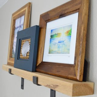 Tutorial on how to make a rustic modern DIY picture ledge and where to find the chunky industrial hardware.  Plus, simple step by step instructions on how to hang level picture ledges. Part 1 of 2, next learn how to create and style a wall vignette with picture ledges.