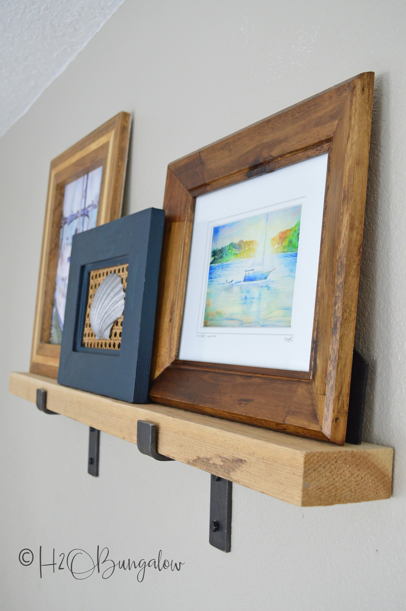 Tutorial on how to make a rustic modern DIY picture ledge and where to find the chunky industrial hardware.  Plus, simple step by step instructions on how to hang level picture ledges. Part 1 of 2, next learn how to create and style a wall vignette with picture ledges.