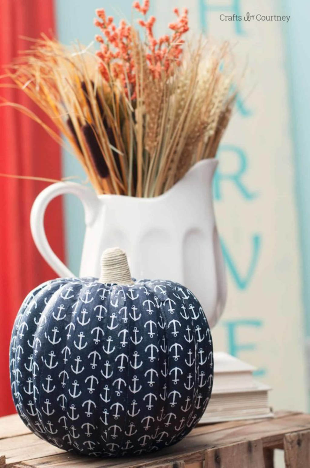 coastal fall decor idea using pumpkin covered in boat anchor motif fabric