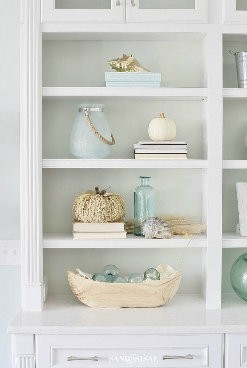 bookcase decorated with coastal fall decor ideas