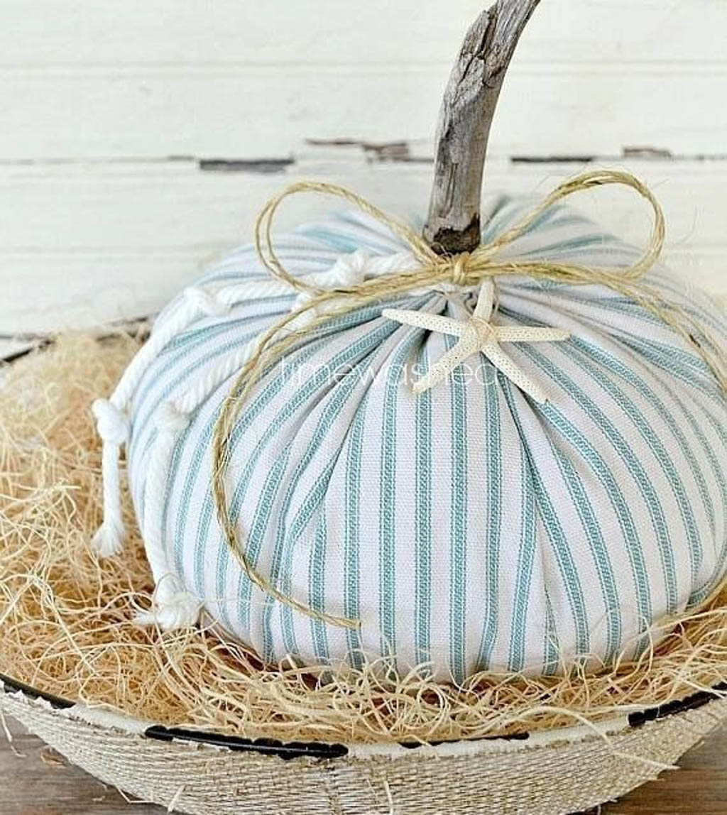 fabric pumpkin with star fish tied to it with twine