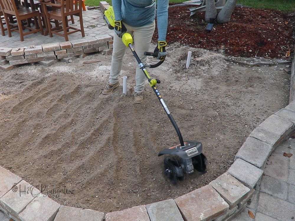 breaking up the soil in new landscape bed