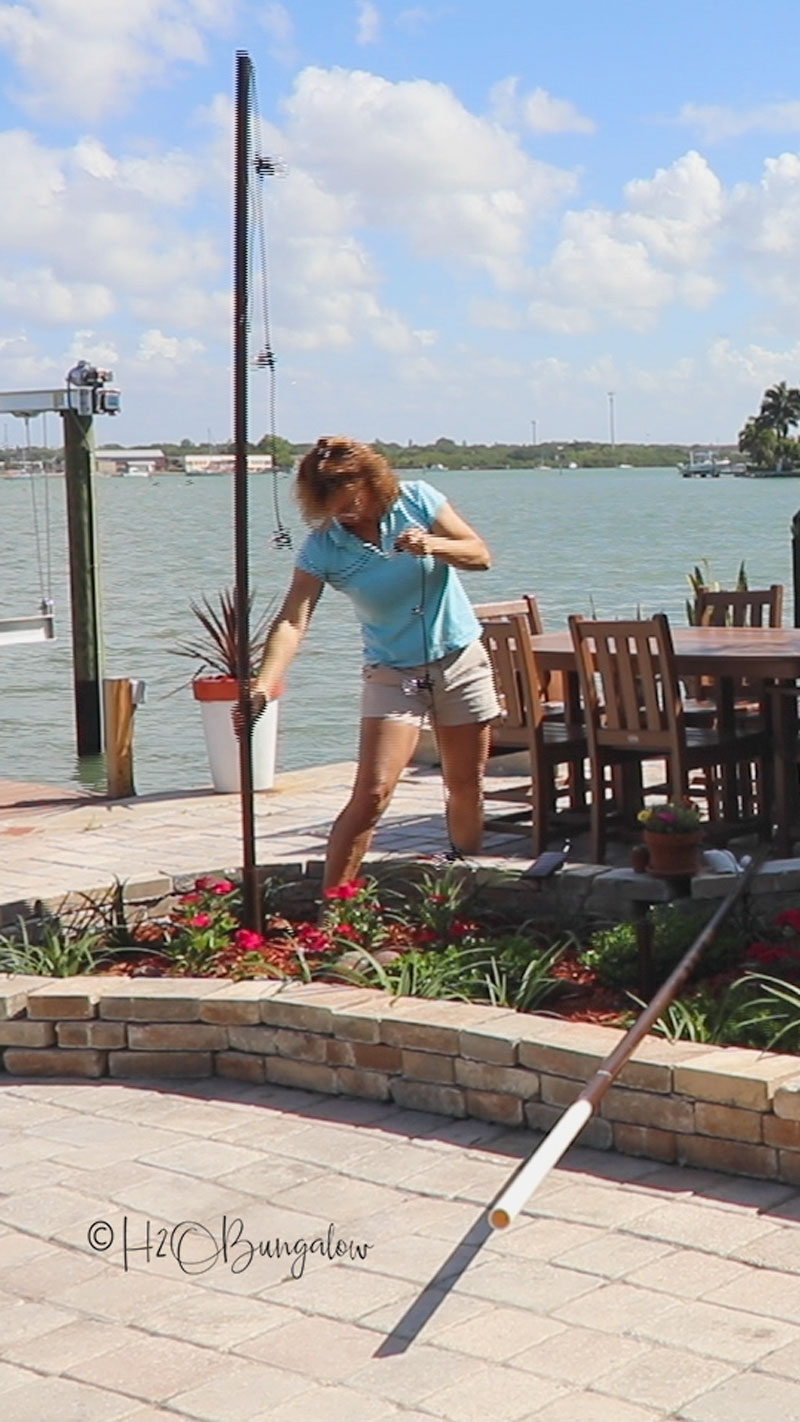 Wendi attaching string lights to pole