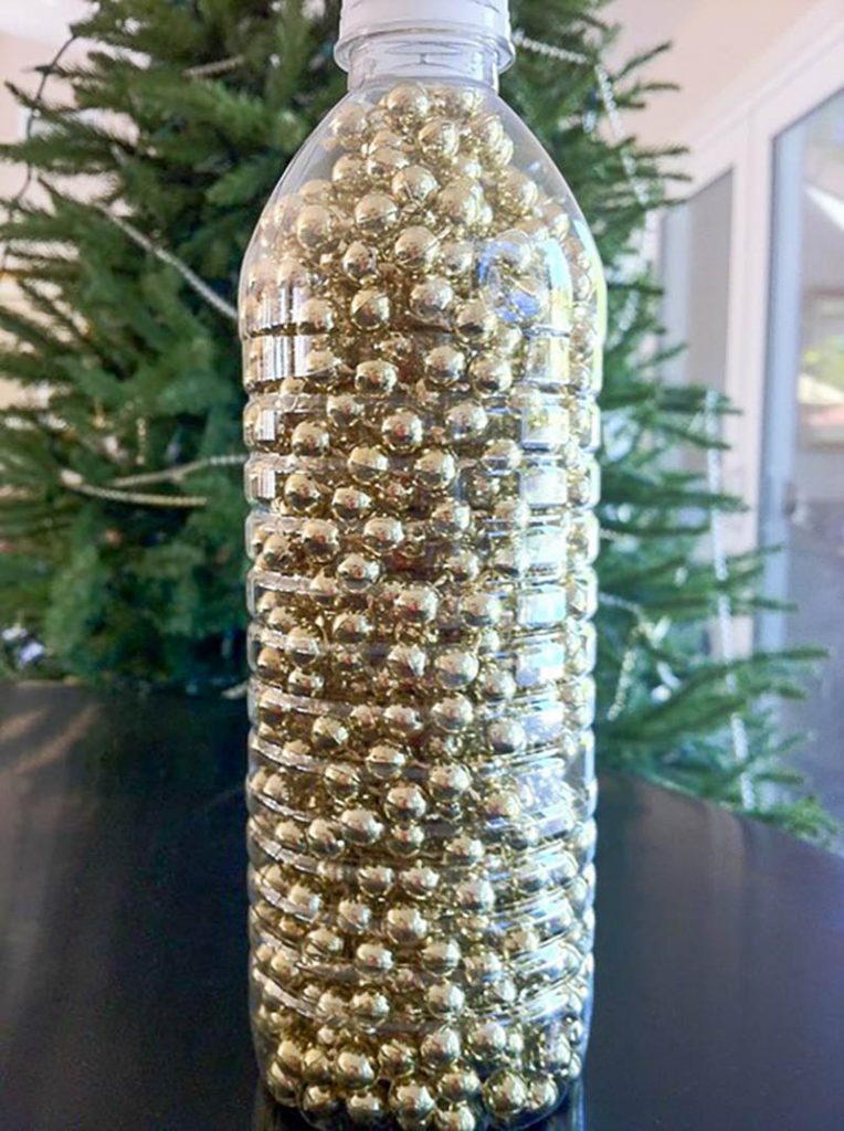 gold sting of bead garland in a plastic bottle