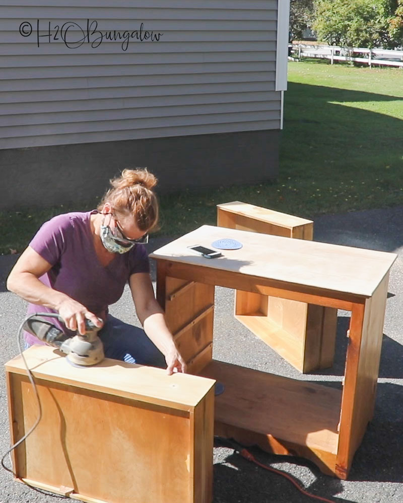 sanding a dresser with an electric random orbital sander