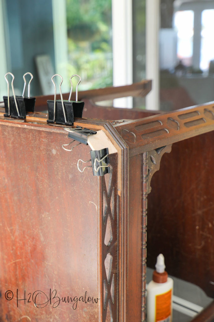 Vintage dark stained wood table with repairs before painting 