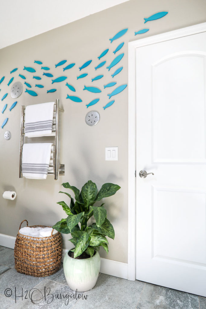 teal swimming fish wall mural on wall 