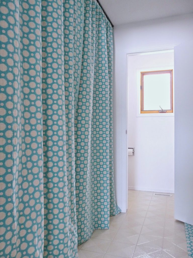 use curtains to hide a section of a room 