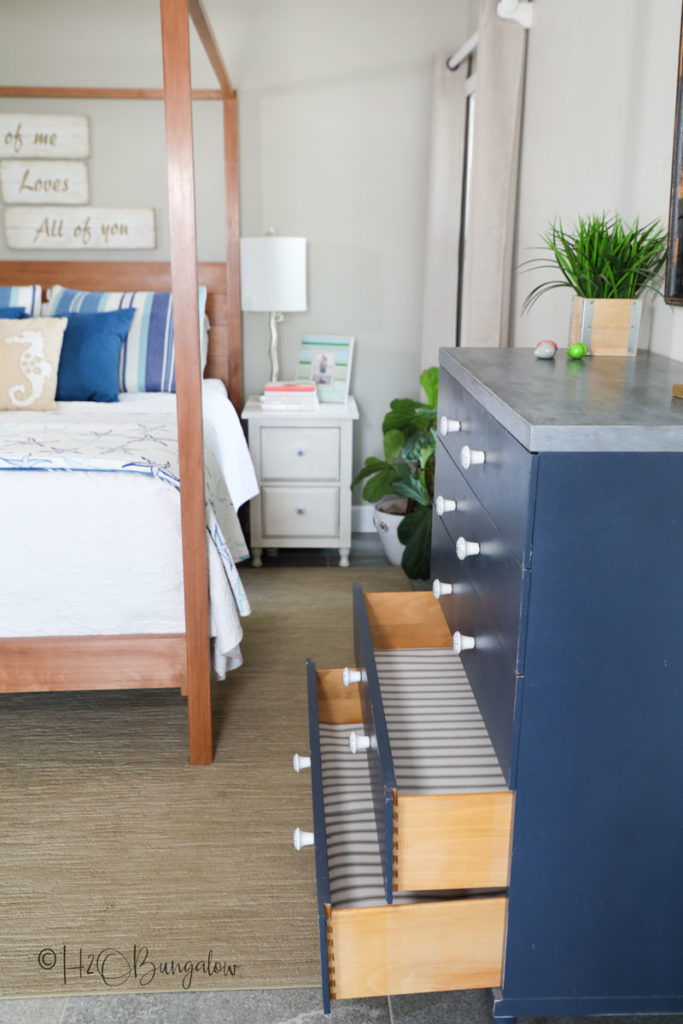 bedroom with lined drawers of a dresser open with shelf liner 