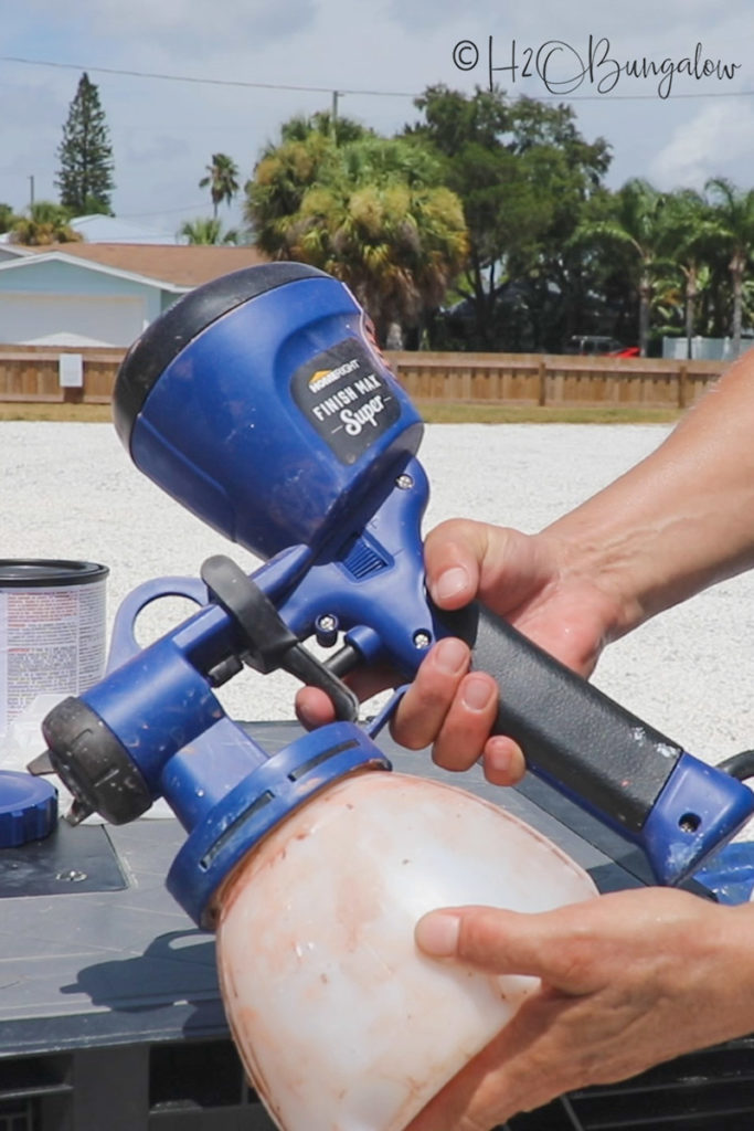 demonstrating how to use paint sprayer