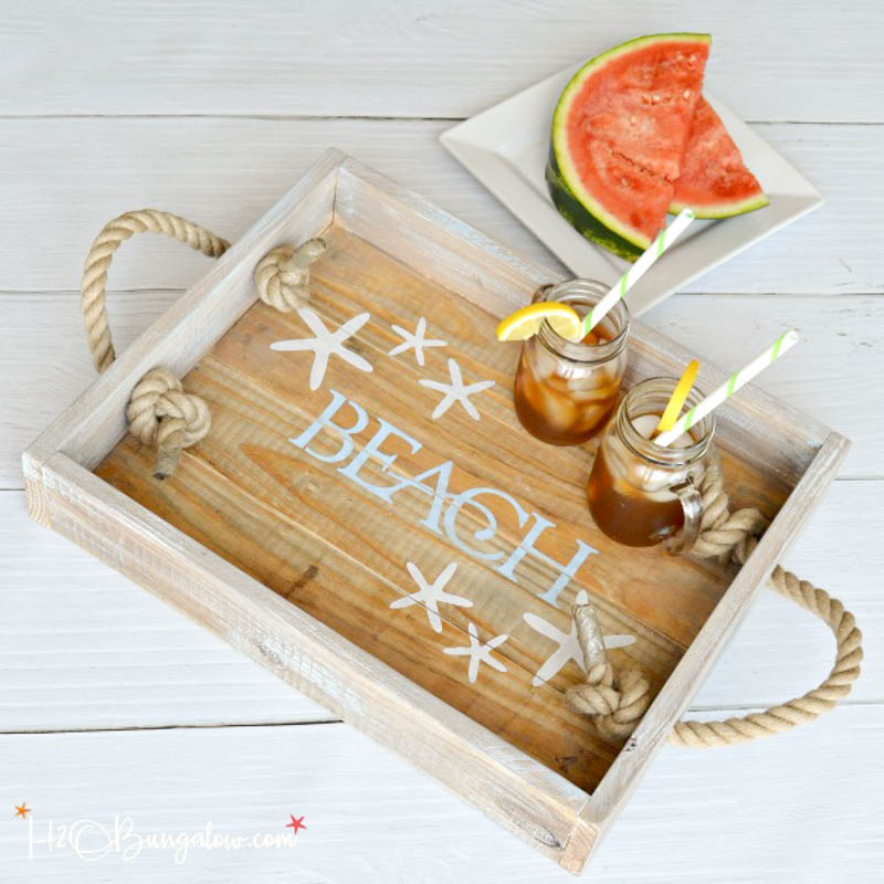 Wooden serving tray with "Beach" stencil and rope handles