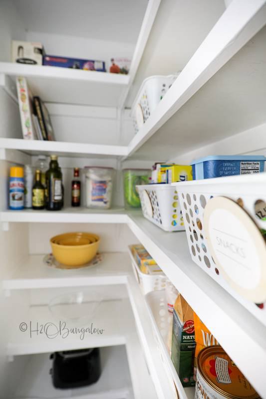 organized pantry with bins and freshly painted