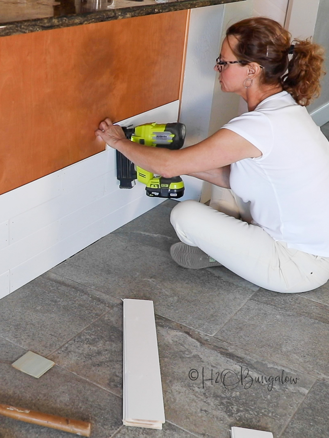 adding wood trim to front of kitchen island base for makeover 