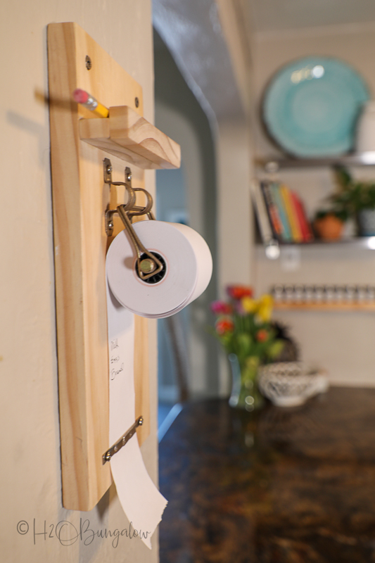 DIY paper roll note holder on wall in kitchen 