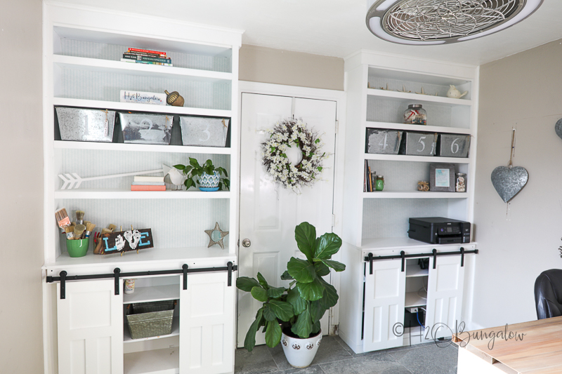 office built in shelves with removable shelf liner decorating back of bookcases 