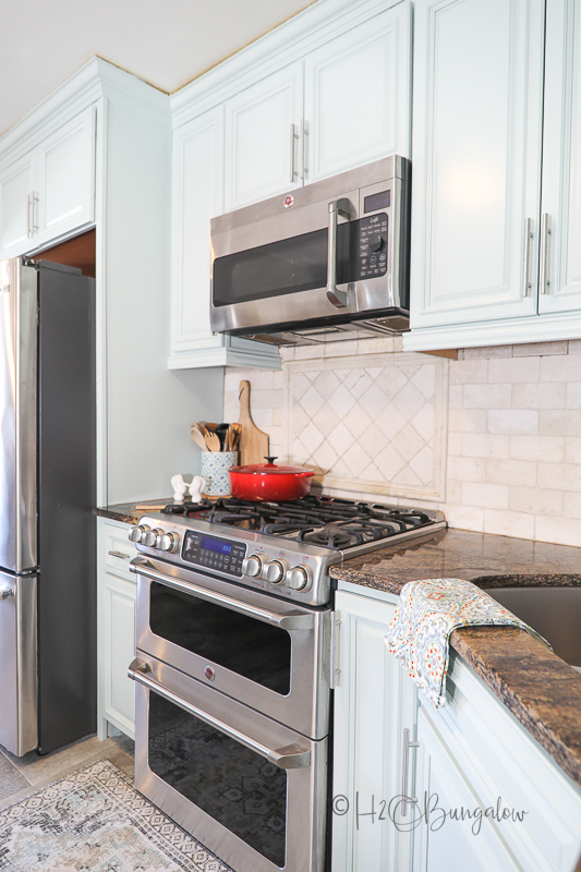 blue cabinets with 6 burner stove 