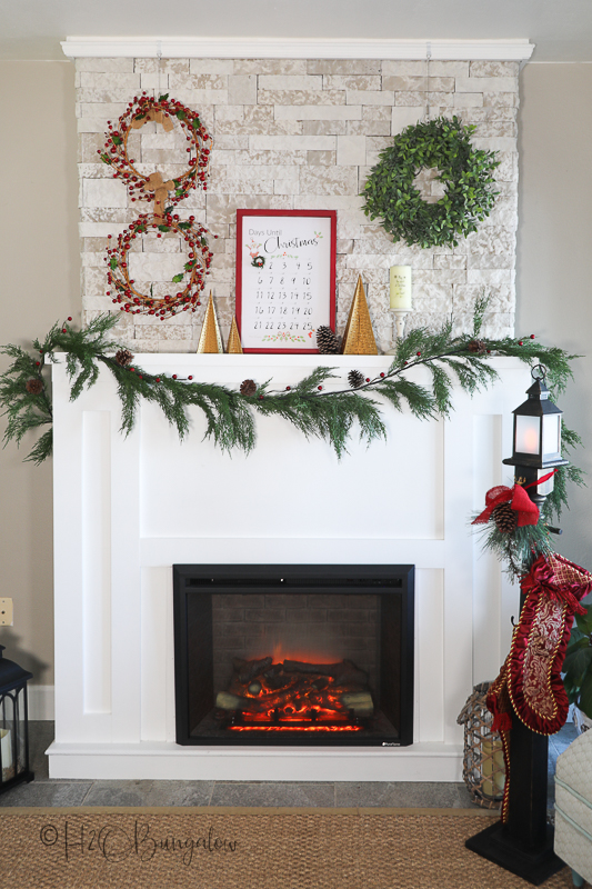 finished Freestanding wood Christmas trees on fireplace mantel