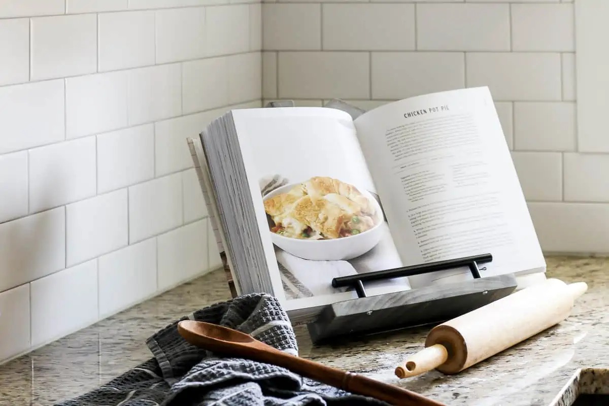 DIY cookbook stand kitchen organizing idea with cookbook sitting on the counter