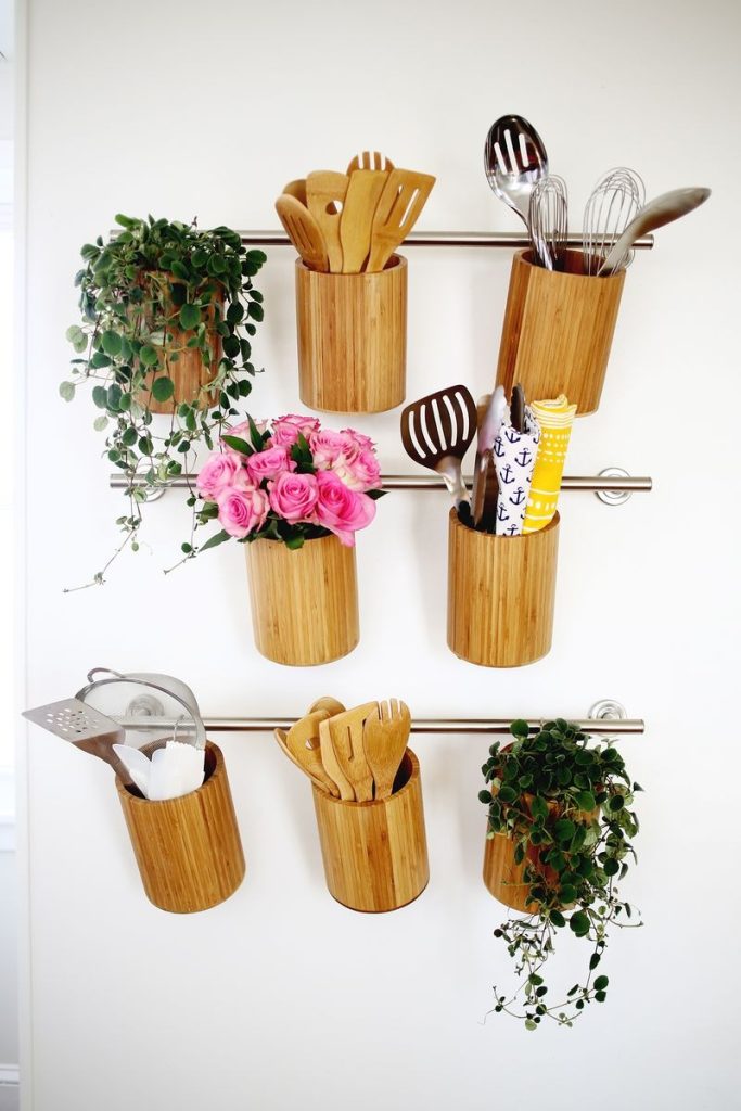 wooden utensil holders hanging on towel bars on the wall